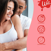 A smiling woman in a white tank top is hugged from behind by a man. On the right, icons highlight "Strawberry," "Sugar Free," and "Clear Non-Staining" benefits of Wet Delicious Oral Play Strawberry Flavored Lube (4oz) under the red Wet logo.